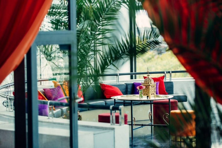 Terrace decorated with red cushions and a lantern for Interface’s drinks reception at the Institut du monde arabe