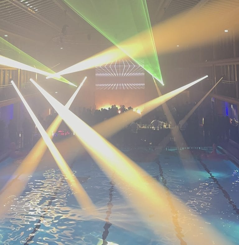 Laser beams and moving lights over the Molitor pool during an evening organised by Weevup