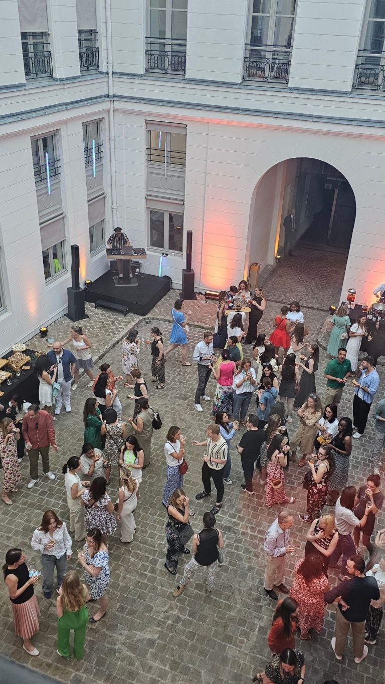Overhead view of Coty’s summer party in the courtyard of its offices, with a DJ and guests standing