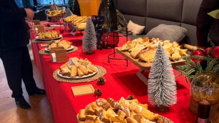Goûter de Noël servi à SSGA au Pathé Beaugrenelle : parts de gâteau, nappe rouge, petits sapins enneigés et boules rouges