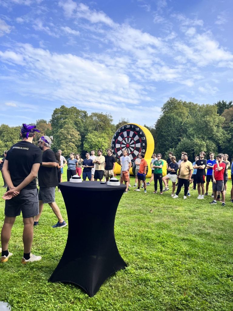 Participants rassemblés dans le parc du château devant une cible géante gonflable, au début des olympiades