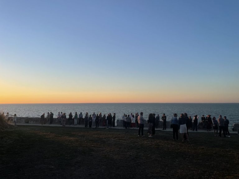 Collaborateurs d’Excelia réunis au bord de la mer au coucher du soleil, pendant la soirée au Bastion, à Saint-Martin-de-Ré, sur l’île de Ré