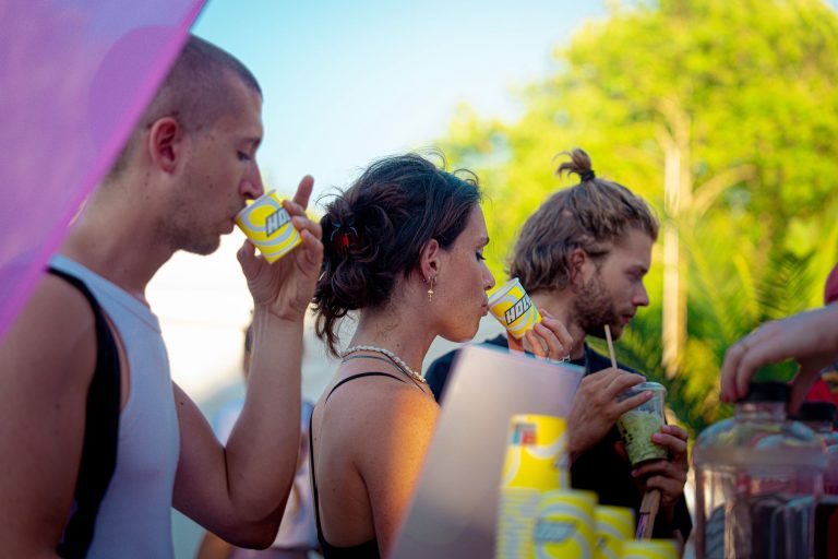 Festivaliers dégustant les boissons Holy en gobelet au comptoir de la remorque-bar, au Lovely Brive Festival