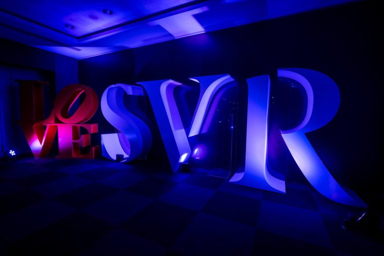 Grandes lettres « LOVE » et « SVR » éclairées en bleu et violet dans la salle du séminaire international SVR organisé par Weevup à Paris