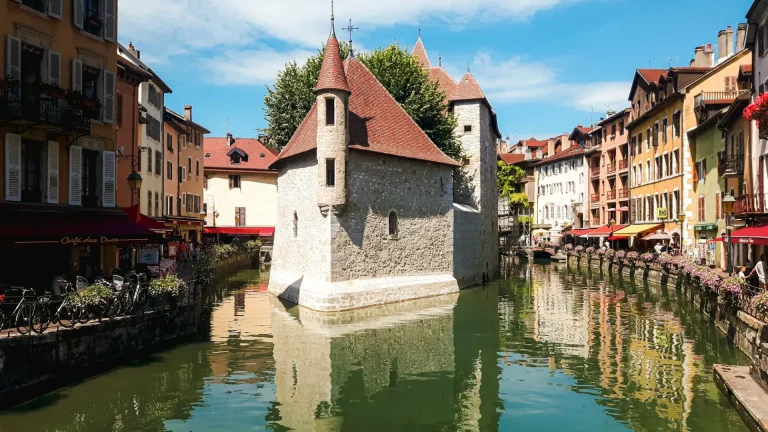 Le Palais de l’Île sur le Thiou, au cœur de la vieille ville d’Annecy, entre façades colorées et quais fleuris