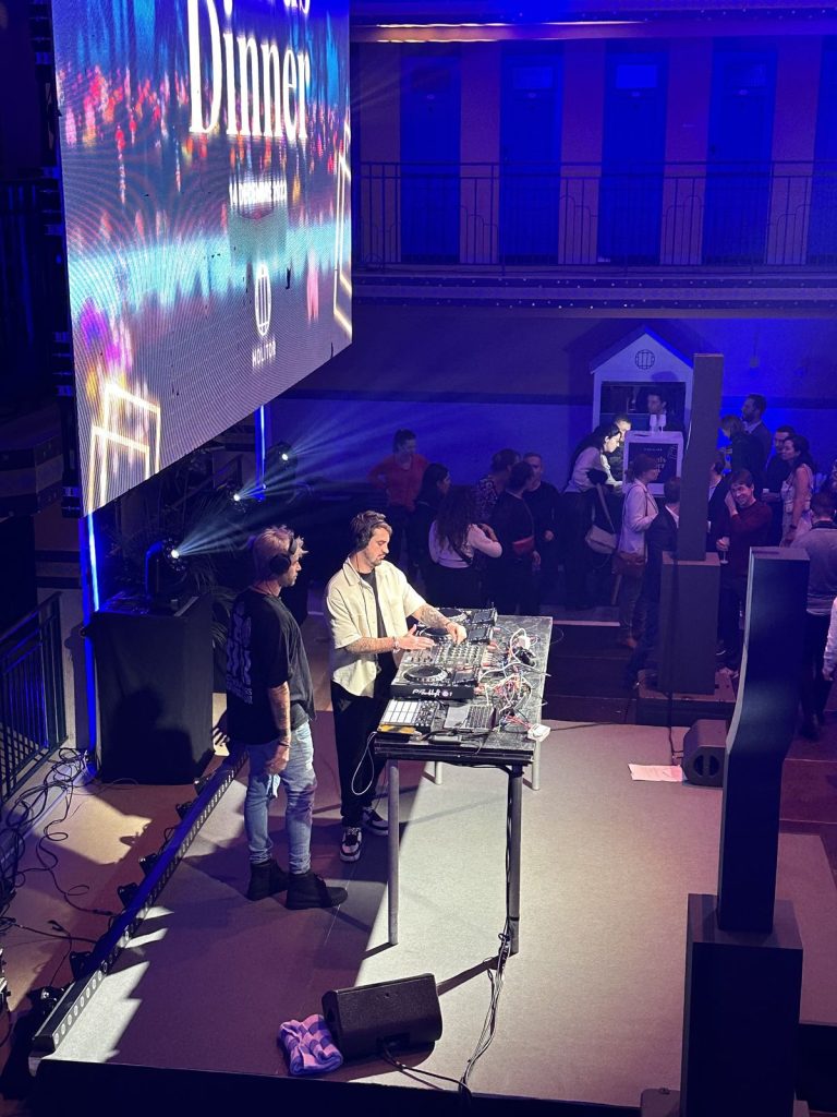 DJ aux platines sur la scène de la soirée awards Scalian au Molitor, sous l’écran LED affichant la date du 14 décembre 2023