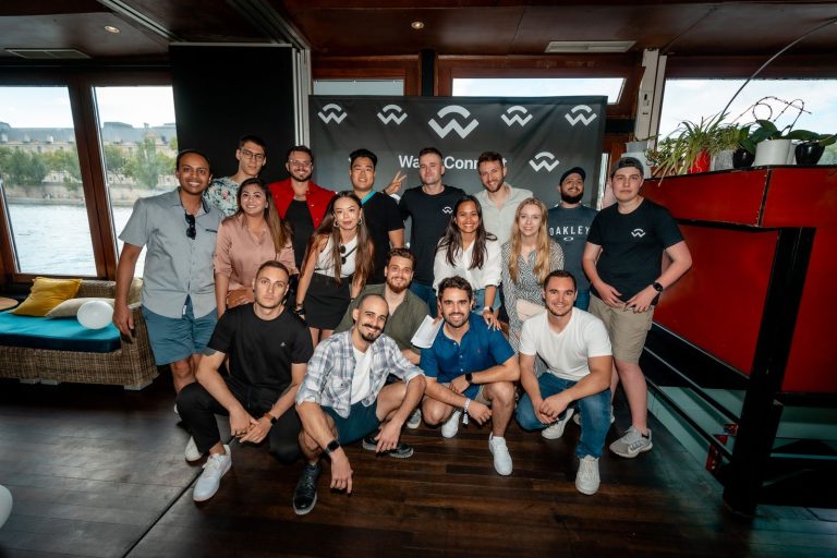 Group photo in front of the WalletConnect photo wall, inside the La Balle au Bond boat, during the launch party on the Seine