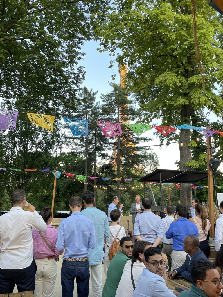 Summer Party KPMG à l’Aquarium de Paris : prise de parole au micro devant les participants, la tour Eiffel entre les arbres